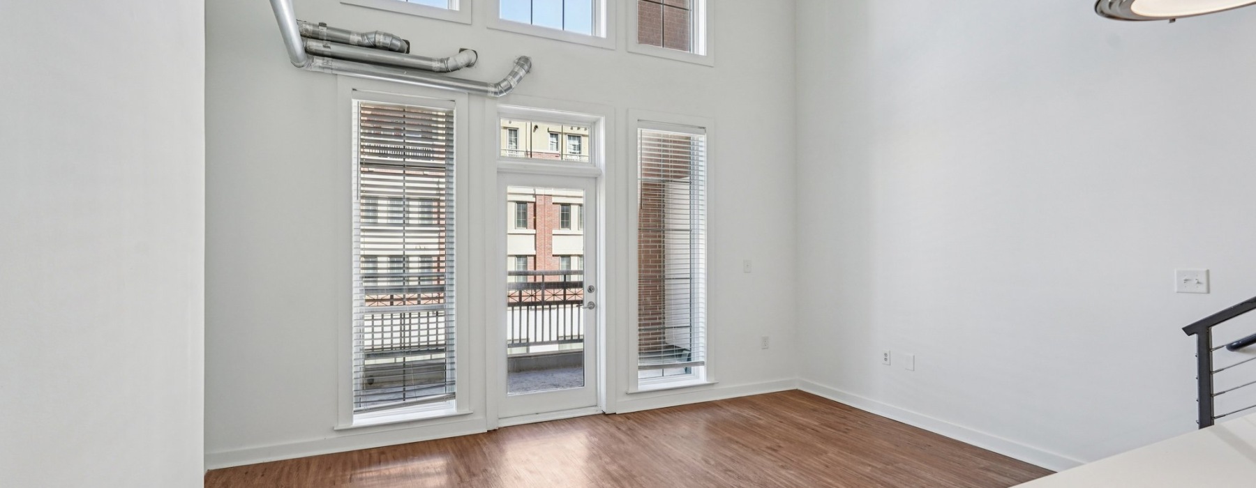 a room with windows and a wood floor