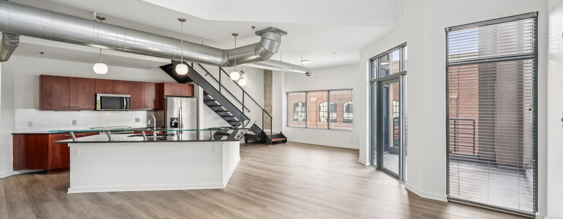 kitchen with an island, modern appliances and nearness to open-concept living areas