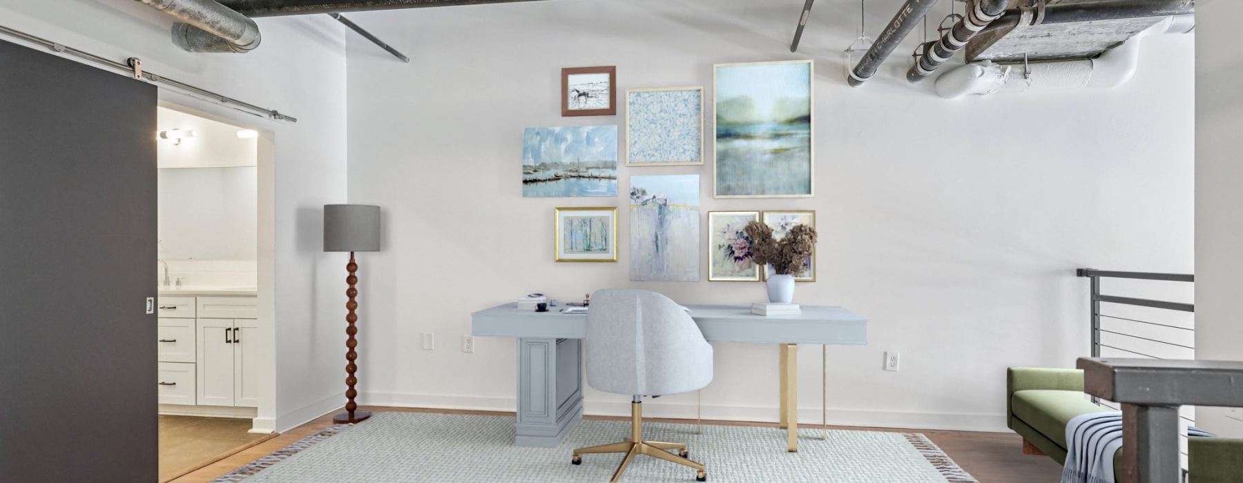 spacious room with art decor and a desk area