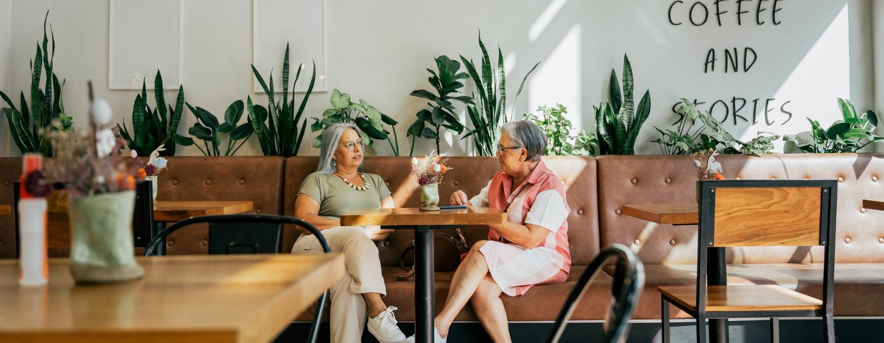 a couple of women sitting at a table talking